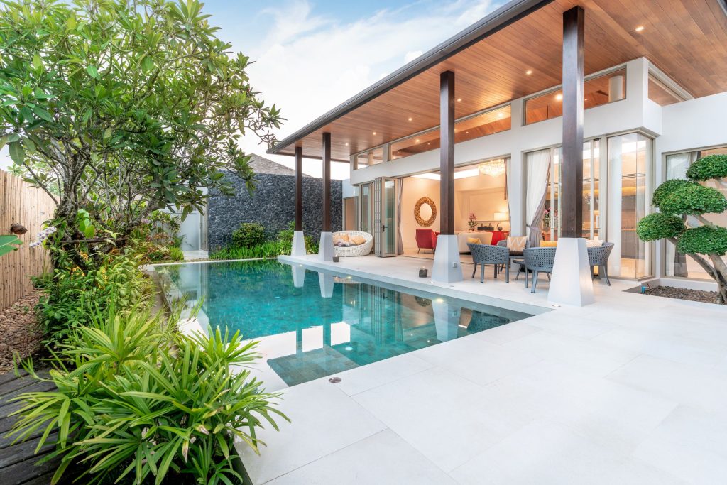 Inspiration for a contemporary backyard concrete and rectangular pool remodel in Miami