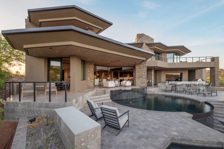 Inspiration for a contemporary backyard ground level mixed material railing outdoor kitchen deck remodel in Phoenix with a roof extension