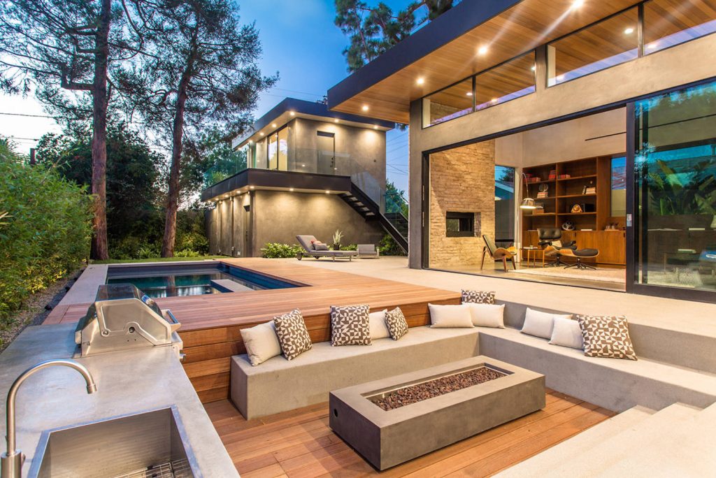 Inspiration for a contemporary backyard patio kitchen remodel in Los Angeles with decking and no cover