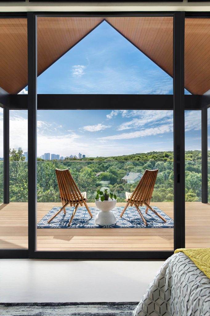 Inspiration for a contemporary second story glass railing deck remodel in Austin