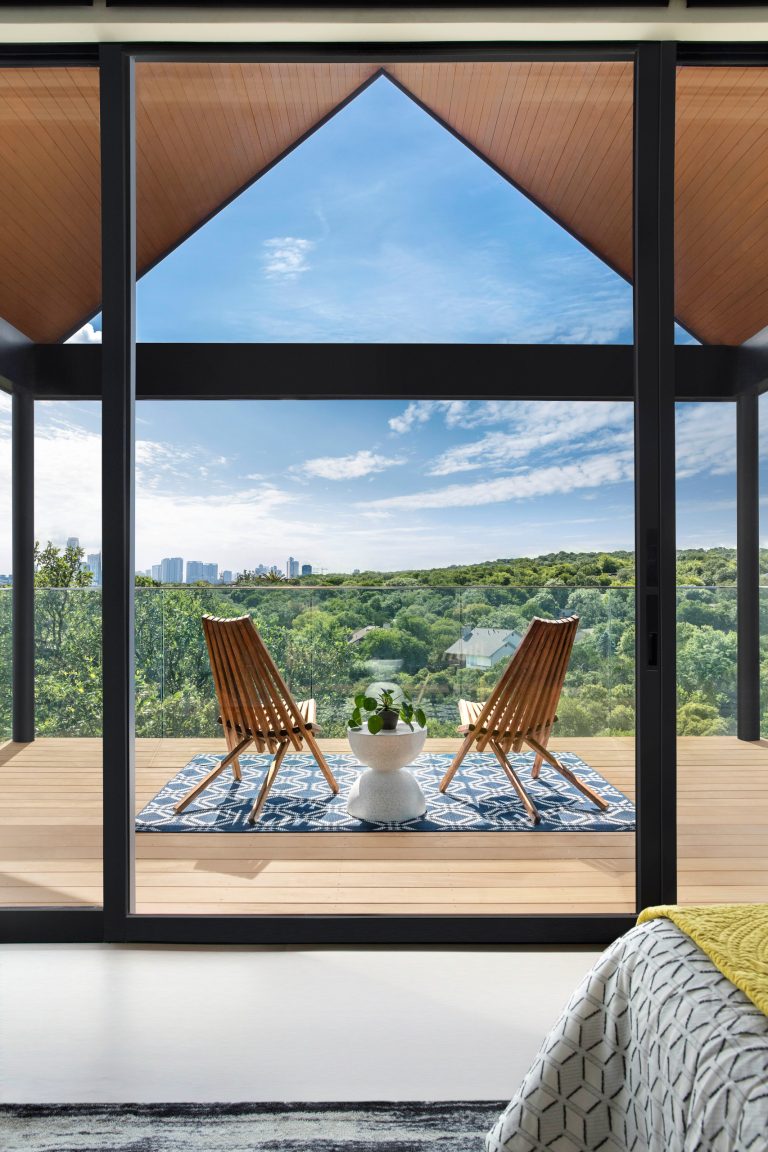 Inspiration for a contemporary second story glass railing deck remodel in Austin