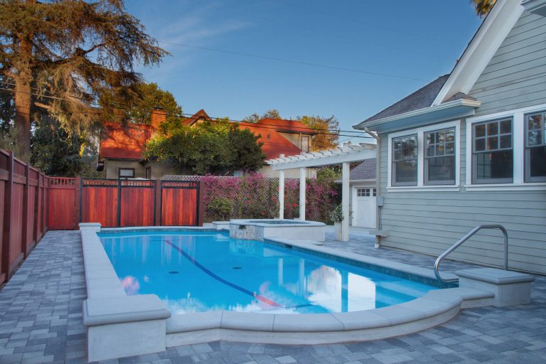 Inspiration for a craftsman backyard concrete paver and custom-shaped hot tub remodel in Los Angeles
