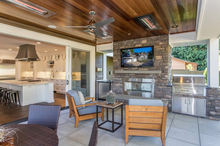 Inspiration for a craftsman concrete paver back porch remodel in Seattle with a roof extension by BDR Fine Homes | Outdoor Photos | Porch | Landscaping | Landscape Design | Outdoor Living Space | Porch Design Ideas | Outdoor Living Space Ideas | Backyard Design