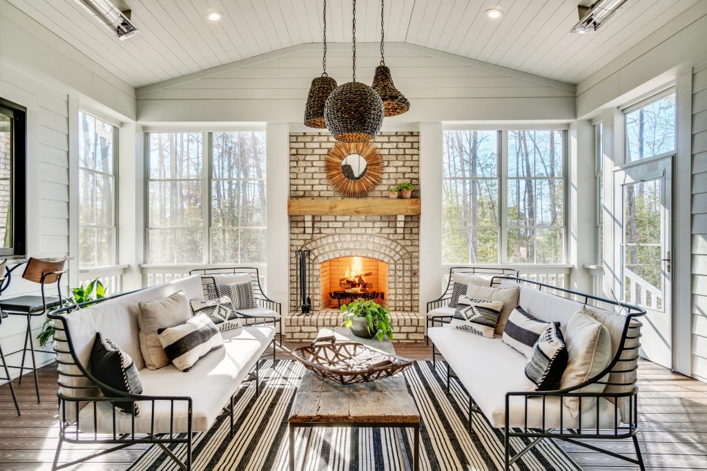 Inspiration for a farmhouse back porch remodel in Richmond with a fireplace, decking and a roof extension by Biringer Builders, Inc. | Outdoor Photos | Porch | Landscaping | Landscape Design | Outdoor Living Space | Porch Design Ideas | Outdoor Living Space Ideas | Backyard Design