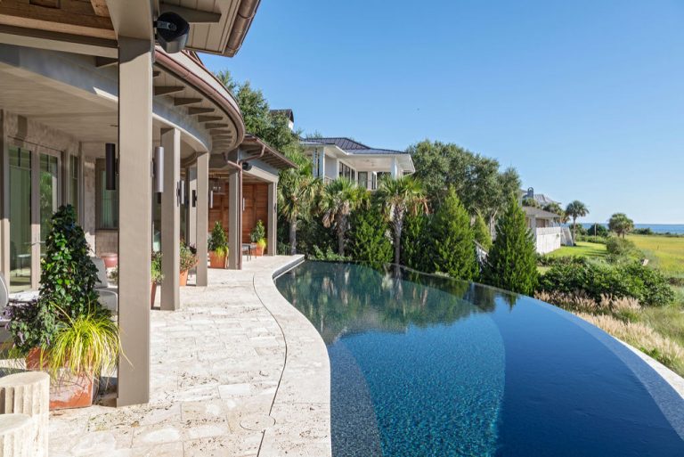 Inspiration for a huge coastal backyard stone and kidney-shaped infinity hot tub remodel in Charleston