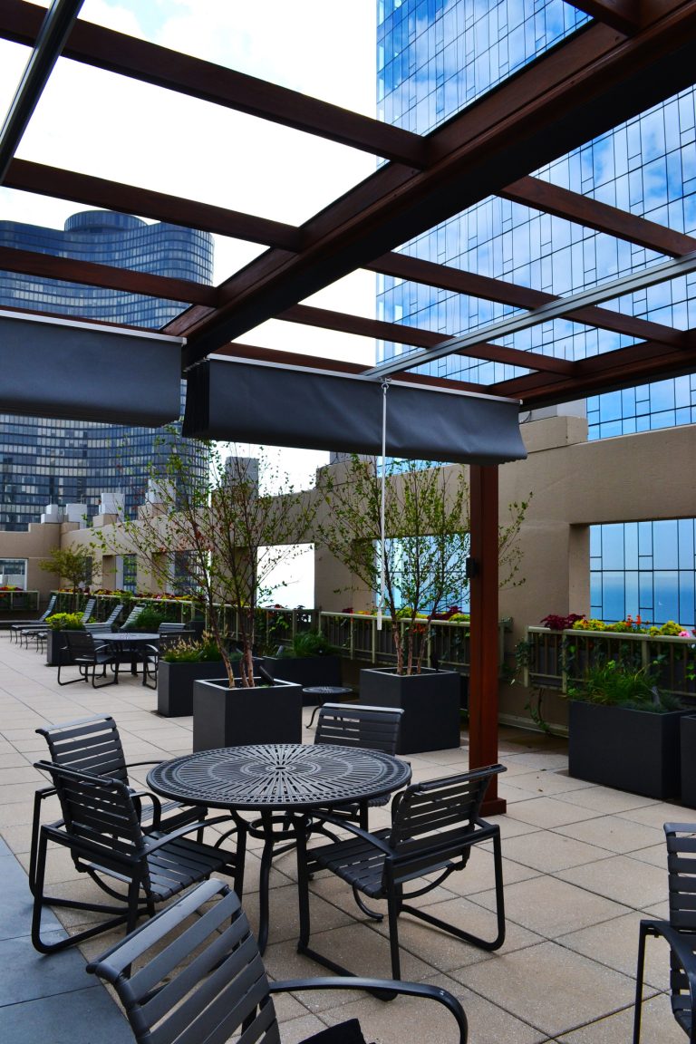 Inspiration for a huge contemporary rooftop outdoor kitchen deck remodel in Chicago with a pergola