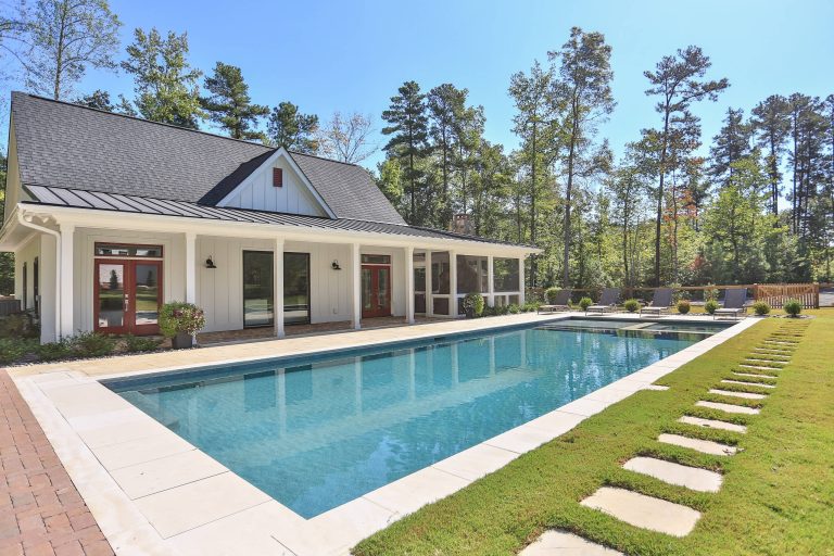 Inspiration for a huge farmhouse backyard stamped concrete and rectangular lap pool house remodel in Raleigh