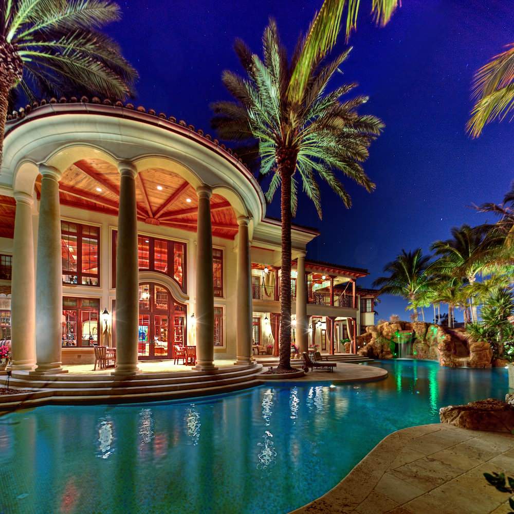 Inspiration for a huge mediterranean backyard custom-shaped natural pool remodel in Miami