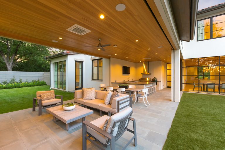 Inspiration for a huge mediterranean backyard stone patio kitchen remodel in Dallas with a roof extension