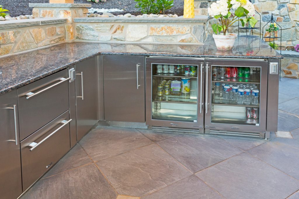 Inspiration for a huge rustic backyard stone patio kitchen remodel in Philadelphia