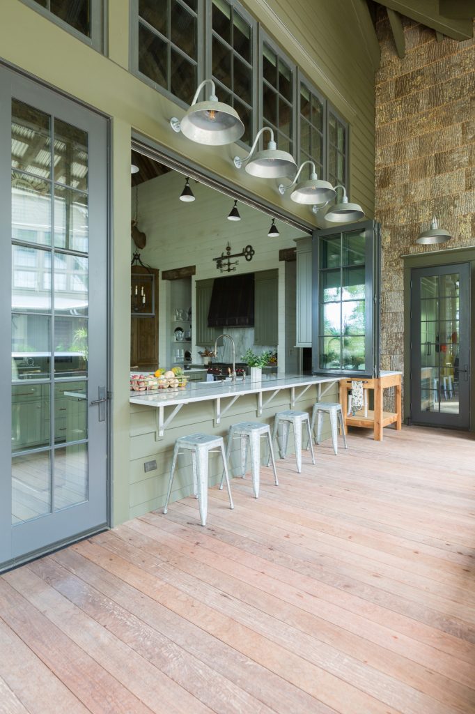 Inspiration for a huge rustic patio kitchen remodel in Other with a roof extension