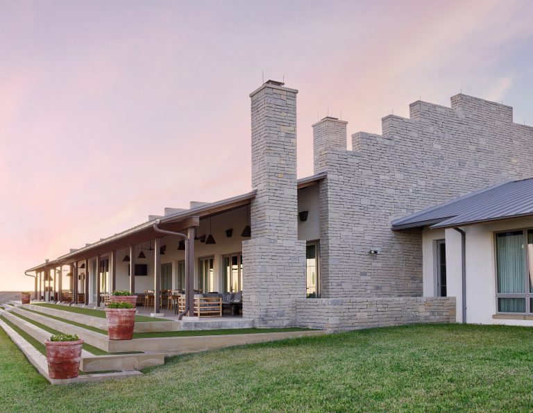 Inspiration for a huge rustic stone porch remodel in Austin
