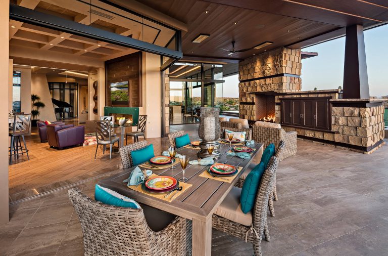 Inspiration for a huge southwestern backyard tile patio kitchen remodel in Phoenix with a roof extension