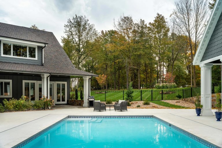 Inspiration for a huge timeless backyard concrete and rectangular pool landscaping remodel in Other