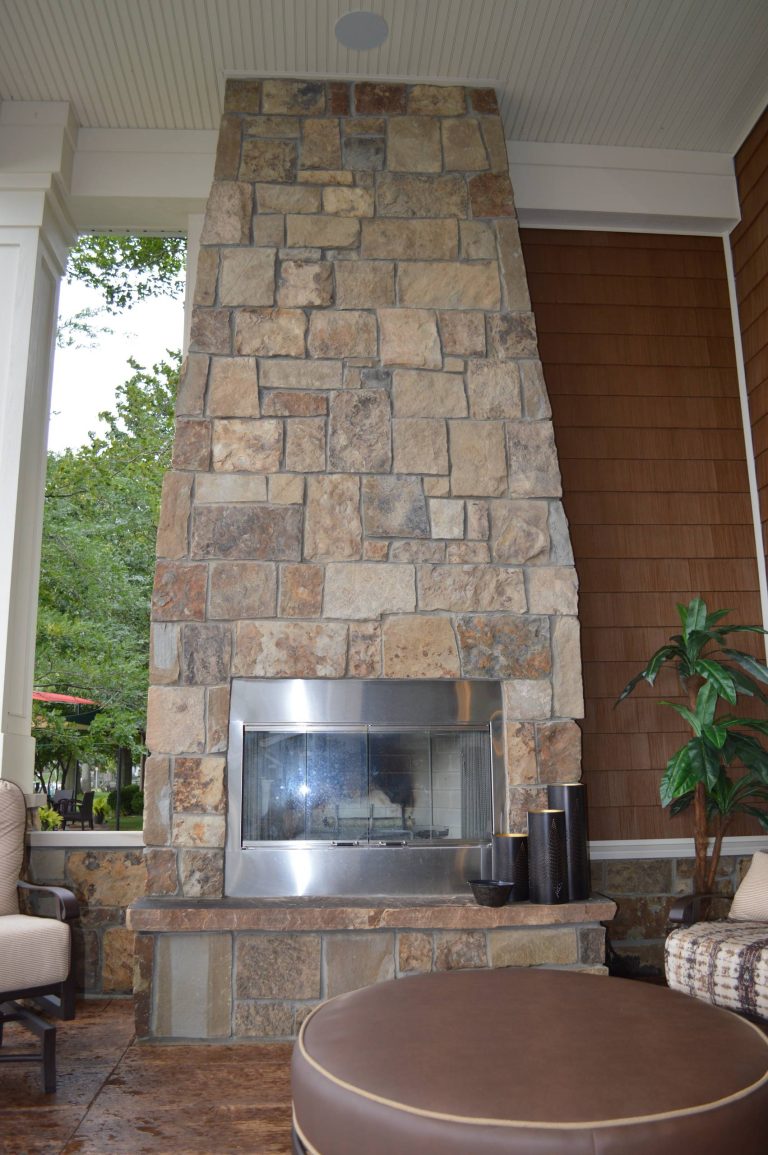 Inspiration for a huge transitional stamped concrete back porch remodel in Grand Rapids with a roof extension by Bob Buescher Homes | Outdoor Photos | Porch | Landscaping | Landscape Design | Outdoor Living Space | Porch Design Ideas | Outdoor Living Space Ideas | Backyard Design