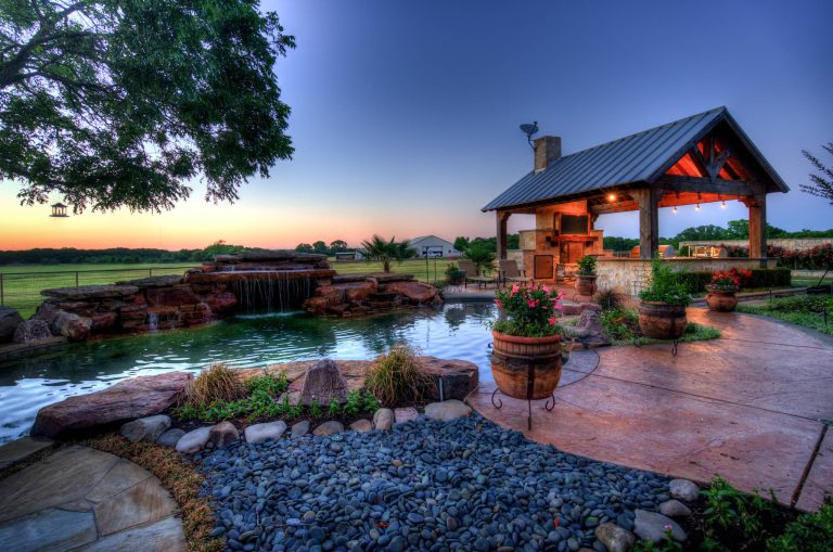 Inspiration for a huge tropical backyard stone and custom-shaped natural hot tub remodel in Austin