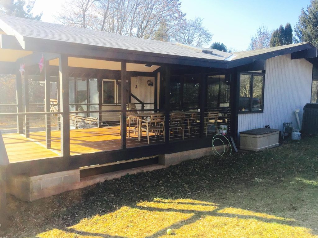 Inspiration for a large 1950s backyard outdoor kitchen deck remodel in Philadelphia with a roof extension