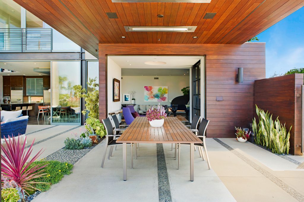 Inspiration for a large 1960s backyard concrete patio kitchen remodel in San Diego with a roof extension