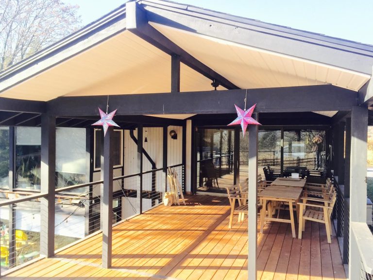Inspiration for a large 1960s backyard outdoor kitchen deck remodel in Philadelphia with a roof extension