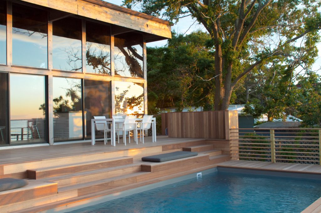 Inspiration for a large 1960s backyard rectangular lap hot tub remodel in New York with decking