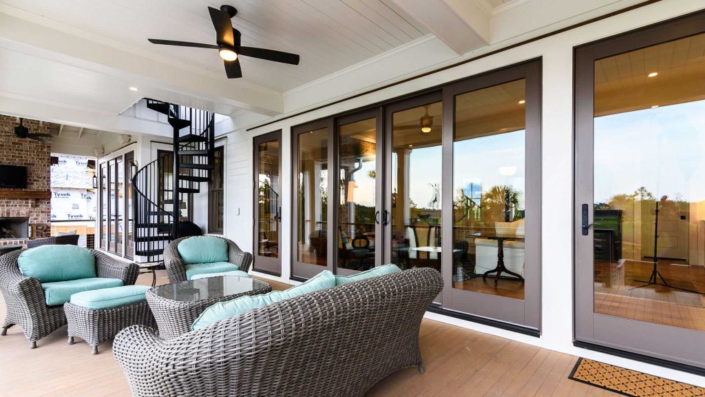 Inspiration for a large coastal back porch remodel in Charleston with a fireplace, decking and a roof extension by Welch Custom Homes | Outdoor Photos | Porch | Landscaping | Landscape Design | Outdoor Living Space | Porch Design Ideas | Outdoor Living Space Ideas | Backyard Design