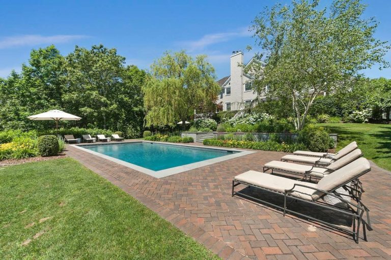 Inspiration for a large coastal backyard brick and rectangular pool remodel in New York