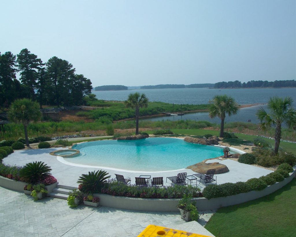 Inspiration for a large coastal backyard concrete and custom-shaped natural hot tub remodel in Other