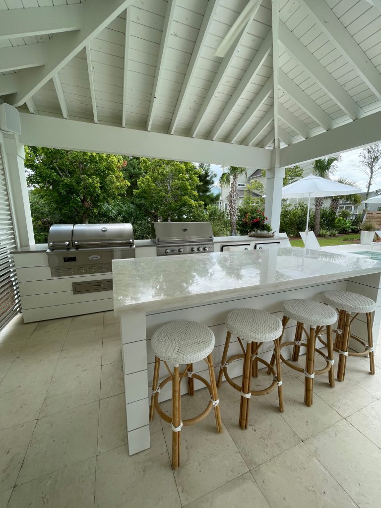 Inspiration for a large coastal backyard concrete paver patio kitchen remodel in Charleston with a pergola