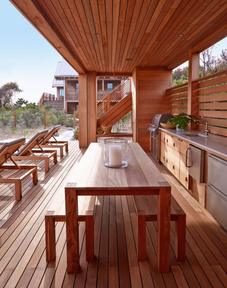 Inspiration for a large coastal backyard outdoor kitchen deck remodel in New York with a roof extension