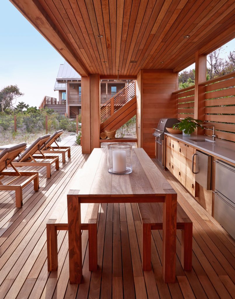 Inspiration for a large coastal backyard outdoor kitchen deck remodel in New York with a roof extension