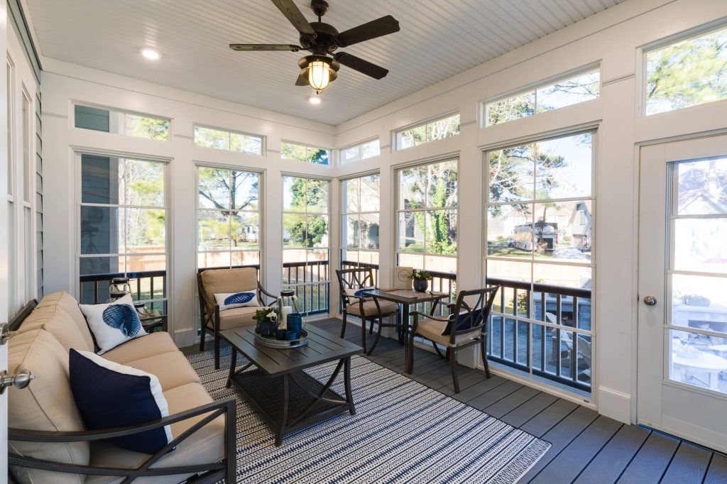 Inspiration for a large coastal screened-in back porch remodel in Other with a roof extension by Stephen Alexander Homes & Neighborhoods | Outdoor Photos | Porch | Landscaping | Landscape Design | Outdoor Living Space | Porch Design Ideas | Outdoor Living Space Ideas | Backyard Design