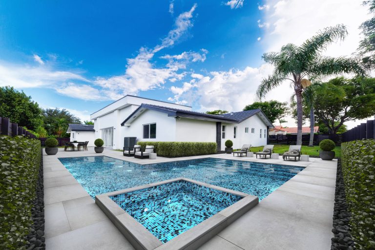 Inspiration for a large contemporary backyard concrete and l-shaped lap hot tub remodel in Miami