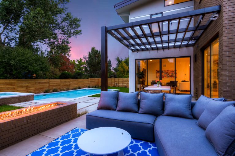 Inspiration for a large contemporary backyard concrete paver patio kitchen remodel in Denver with a pergola
