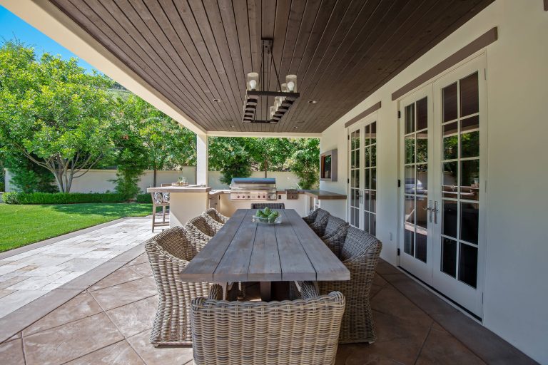 Inspiration for a large contemporary backyard concrete paver patio kitchen remodel in San Diego with a roof extension
