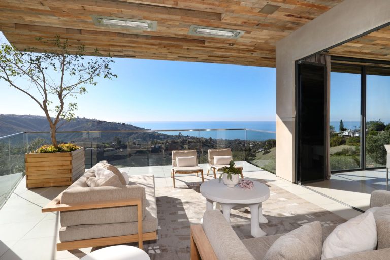 Inspiration for a large contemporary backyard deck remodel in Orange County with a fireplace and a roof extension