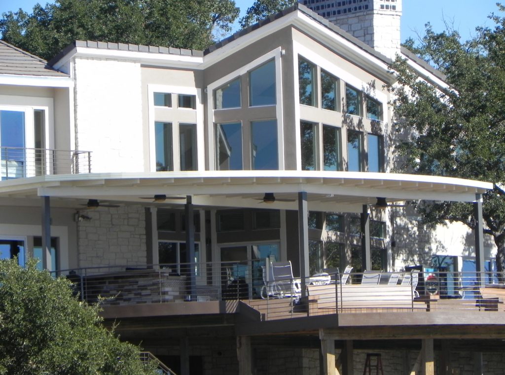 Inspiration for a large contemporary backyard outdoor kitchen deck remodel in Austin with a roof extension