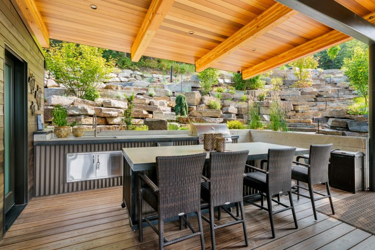 Inspiration for a large contemporary backyard outdoor kitchen deck remodel in Other with a roof extension