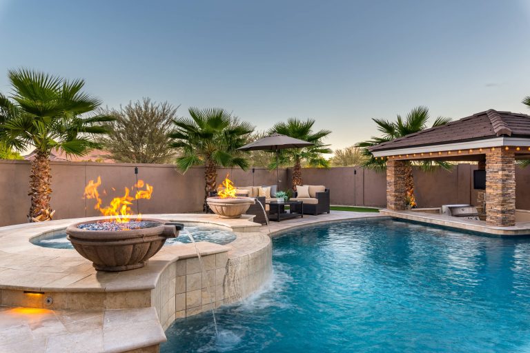 Inspiration for a large contemporary backyard stone and custom-shaped hot tub remodel in Phoenix