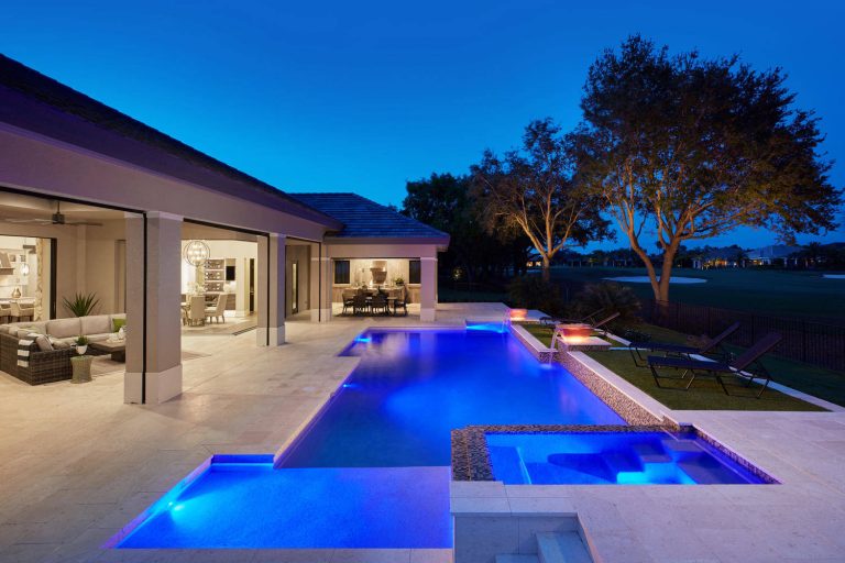 Inspiration for a large contemporary backyard stone and custom-shaped lap pool house remodel in Miami