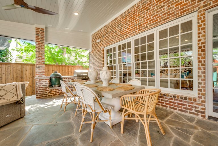 Inspiration for a large contemporary backyard stone patio kitchen remodel in Dallas with a roof extension