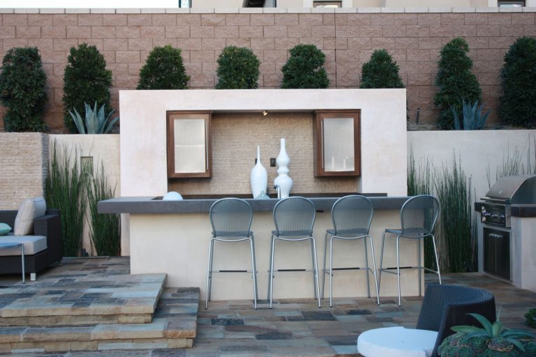 Inspiration for a large contemporary backyard stone patio kitchen remodel in Orange County