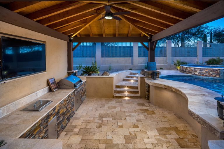 Inspiration for a large contemporary backyard stone patio kitchen remodel in Phoenix with a pergola