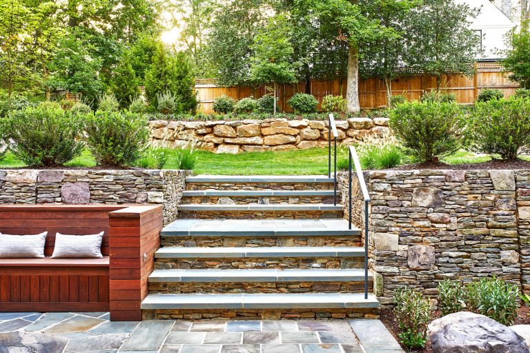 Inspiration for a large contemporary full sun backyard stone retaining wall landscape in DC Metro for summer.