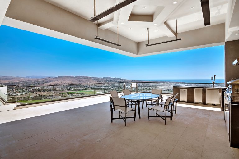 Inspiration for a large contemporary rooftop outdoor kitchen deck remodel in Orange County with a roof extension