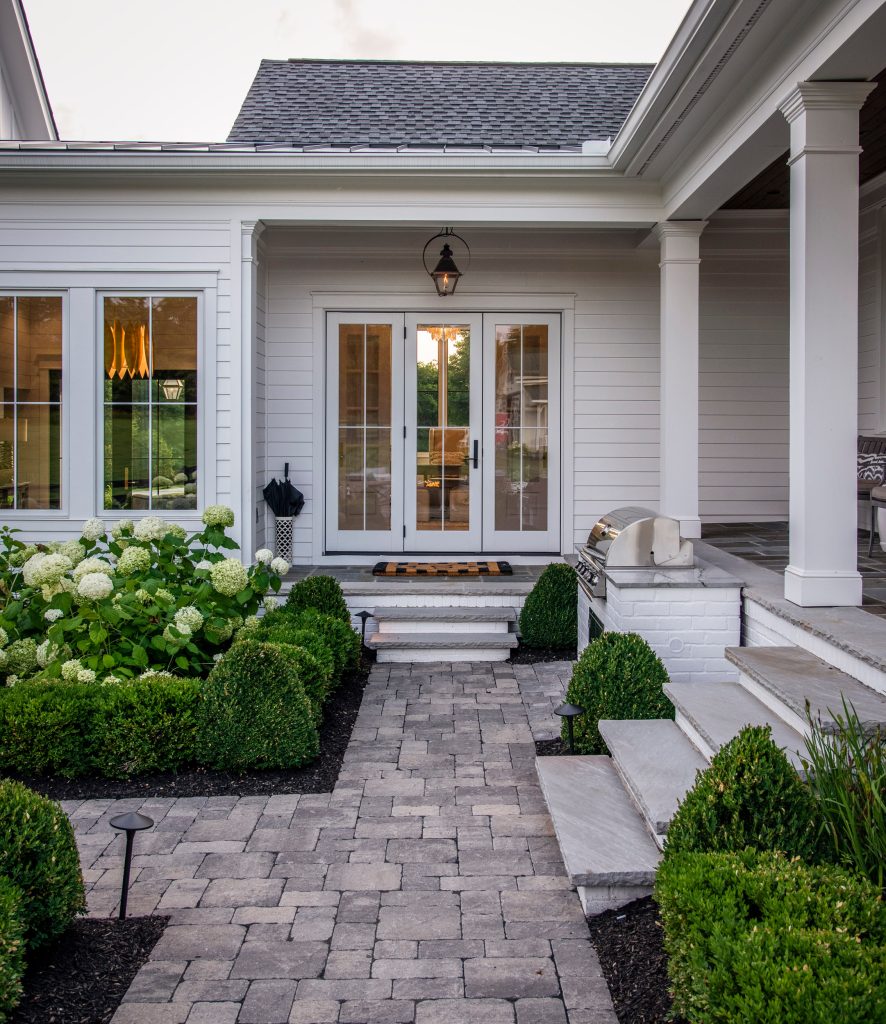 Inspiration for a large cottage stone porch remodel in Nashville with a roof extension by Forte Building Group, LLC | Outdoor Photos | Porch | Landscaping | Landscape Design | Outdoor Living Space | Porch Design Ideas | Outdoor Living Space Ideas | Backyard Design