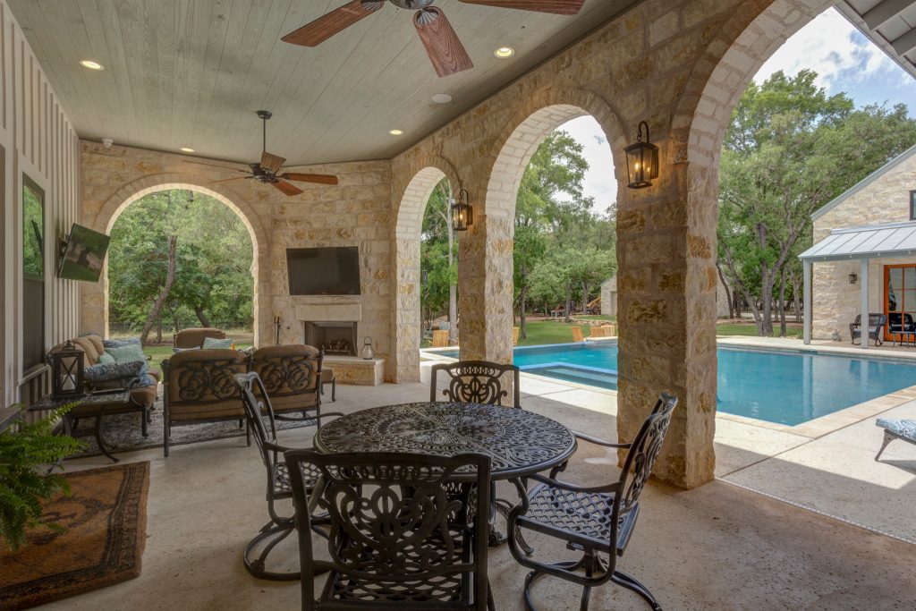 Inspiration for a large country backyard concrete patio kitchen remodel in Austin with a roof extension