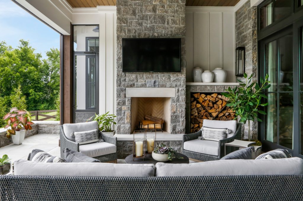 Inspiration for a large country backyard stone patio kitchen remodel in Nashville with a roof extension