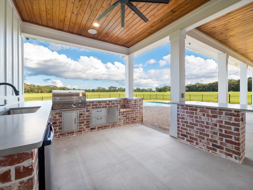 Inspiration for a large country concrete porch remodel in New Orleans with a roof extension by ARK Builders | Outdoor Photos | Porch | Landscaping | Landscape Design | Outdoor Living Space | Porch Design Ideas | Outdoor Living Space Ideas | Backyard Design