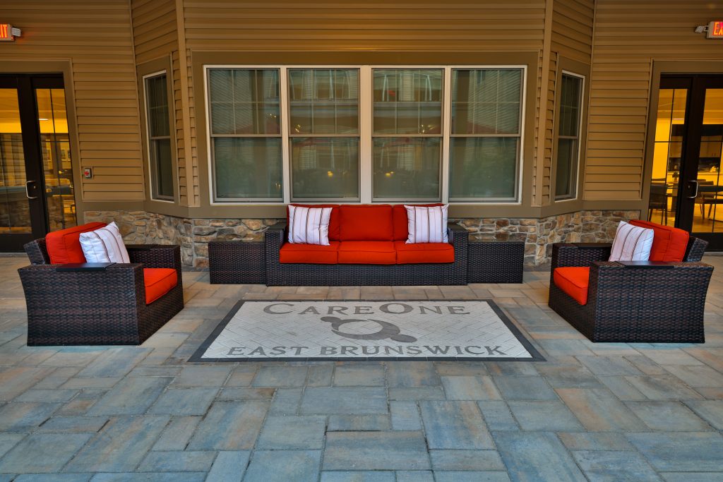 Inspiration for a large courtyard stone patio kitchen remodel in New York with a pergola