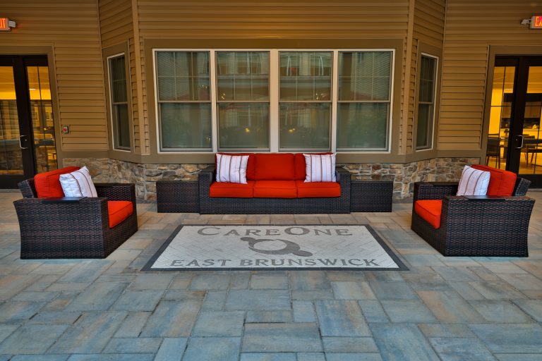 Inspiration for a large courtyard stone patio kitchen remodel in New York with a pergola